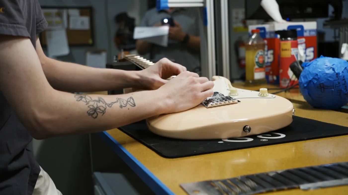 A Corzic technician setting up an electric guitar in the service centre