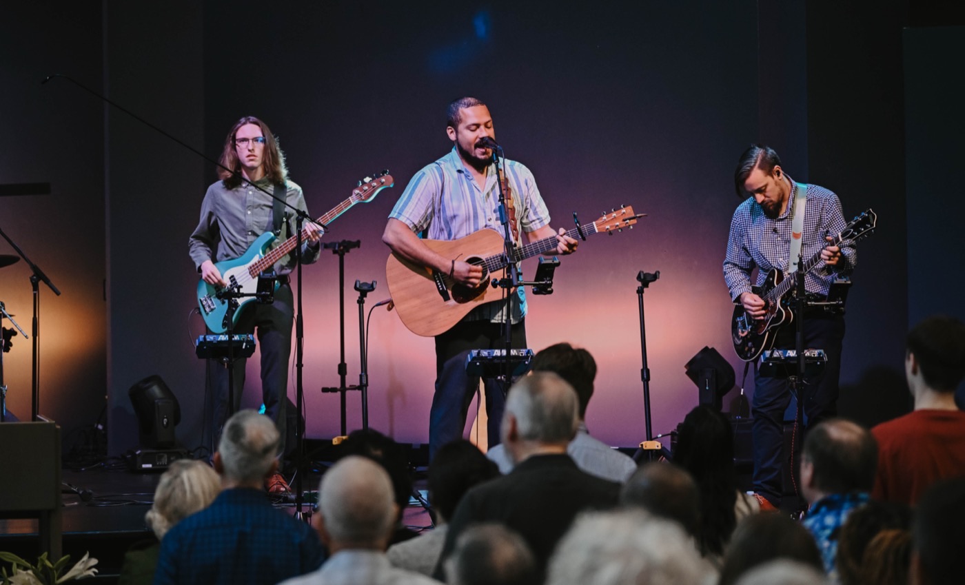 A worship band leading from the stage