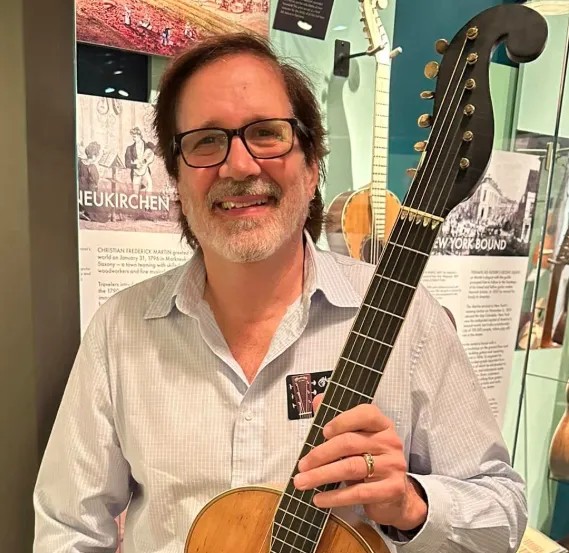 Chuck Yamek holding a vintage Martin guitar